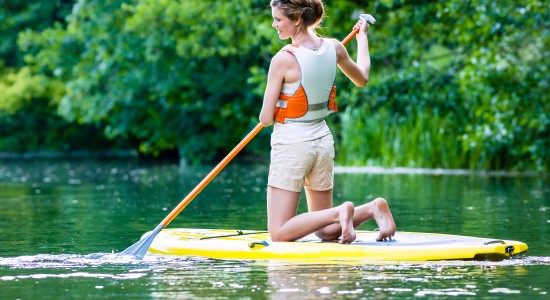 Woman paddleboarding in lake