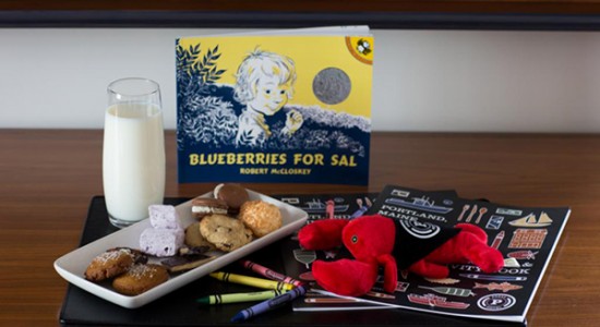 Tray of cookies with milk next to coloring book with crayons & lobster stuffed animal