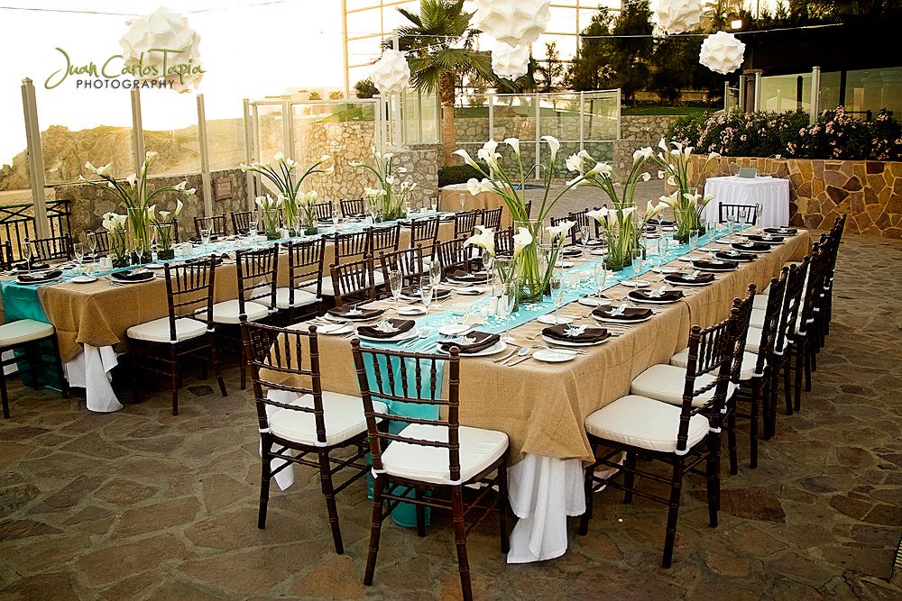 tables on terrace with flowers and brown linen