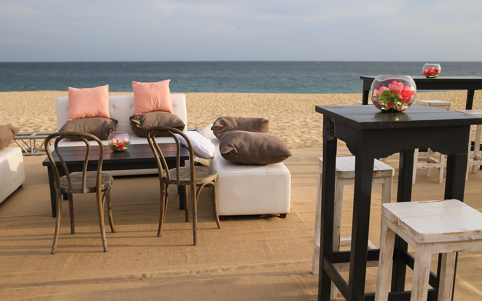 tables, couches, and chairs on beach