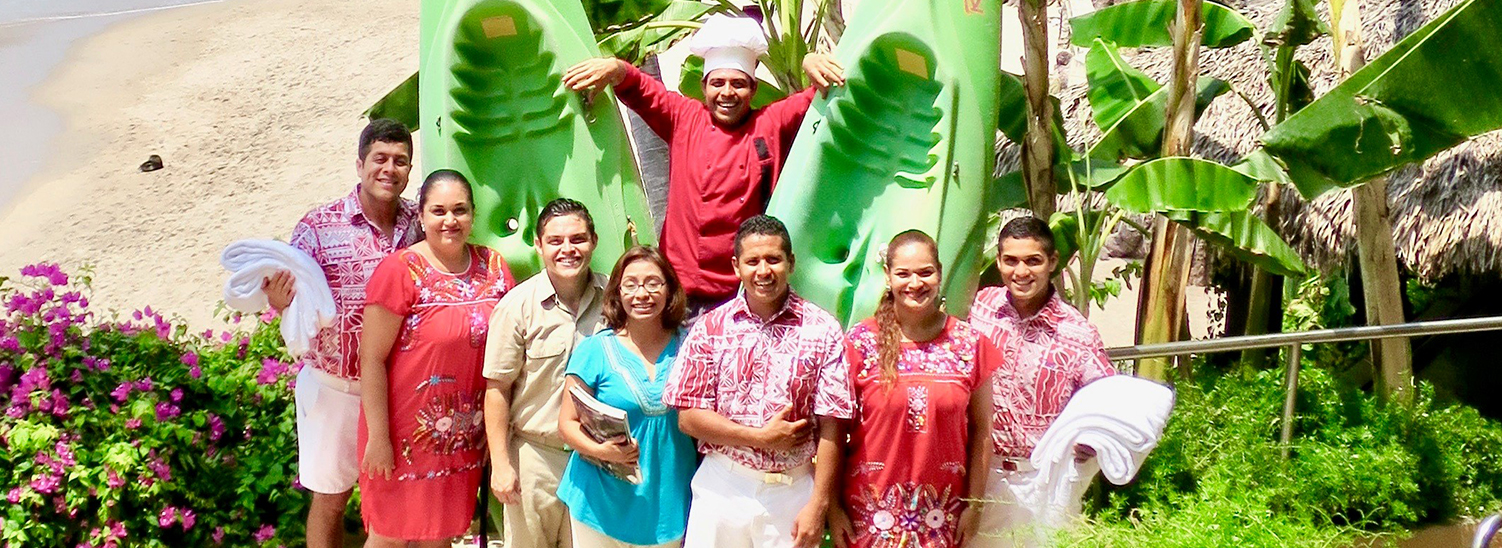 Staff in uniform with two green canoes