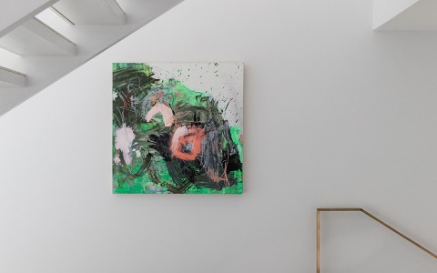 View of a green and pink painting on a white wall 