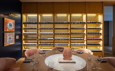 View of a rack full of wine bottles and a table 