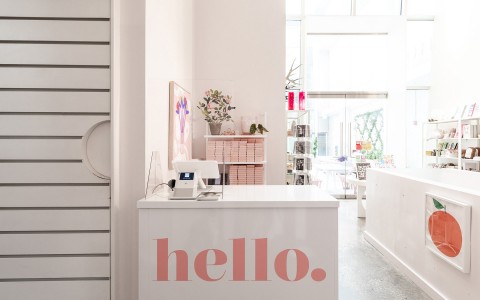 A Hello sign on a cashier machine desk at the Boutique Shop