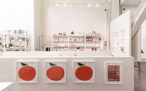 View of three paintings of one red apple at the Boutique Shop