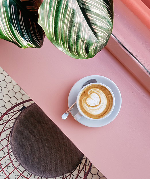 top view of a coffee over a pink table 