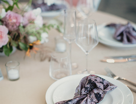 close up of a set table with a purple napkin