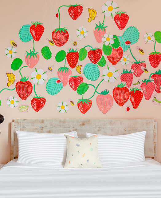 Hotel room with strawberries illustrations in the back wall