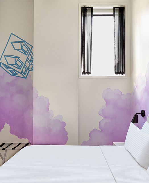 Hotel room with purple clouds painted in the wall 