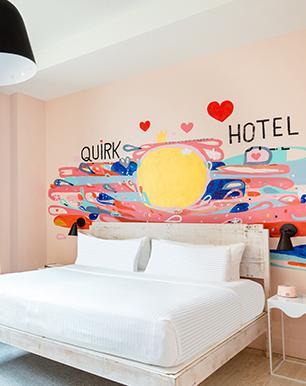 Hotel room with a mural painted in thee wall 