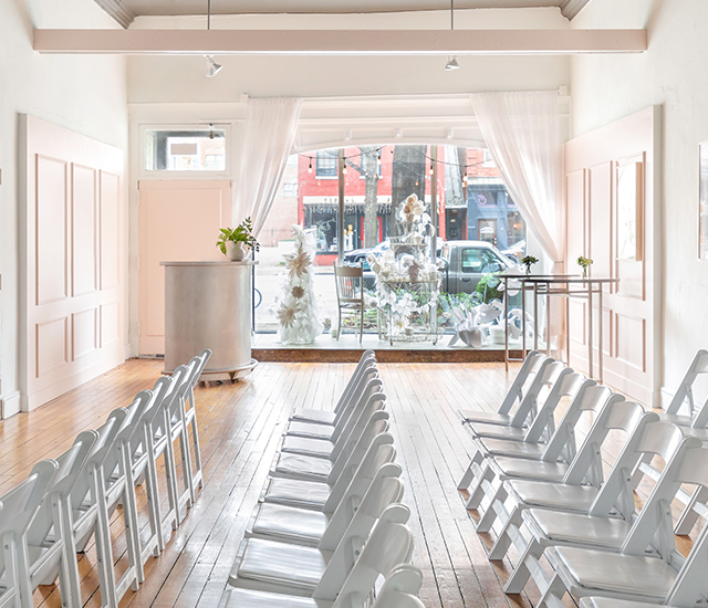 Side view of an event venue with some gray chairs organized