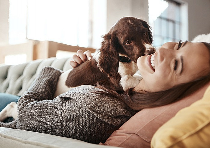 women and dog playing