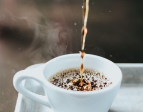 espresso being poured into small mug