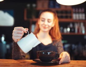 woman getting ready to pour coffee 