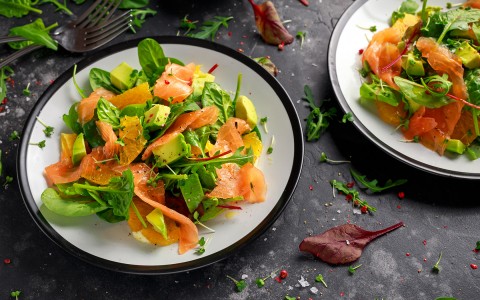 View of two dishes with avocado and salmon salad