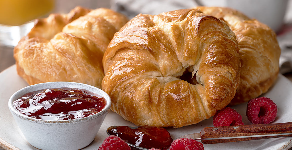 View of three croissants and raspberry marmalade