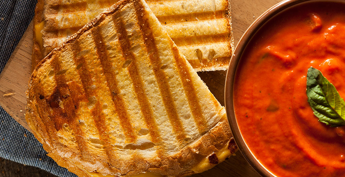 Top view of toasted slices of bread and tomato sauce