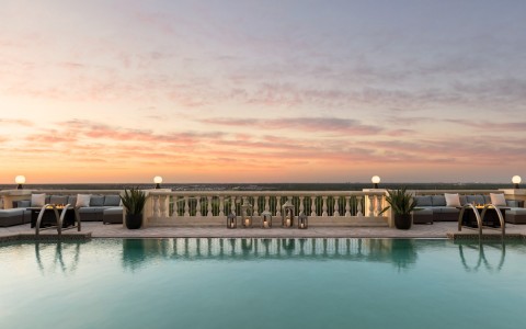 view of property pool with sunsetting in the background