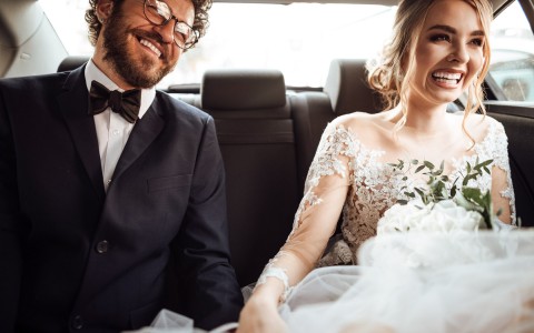 Zoomed view of newlywed couple in a car