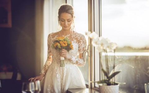 bride with floral bouquet and dress 