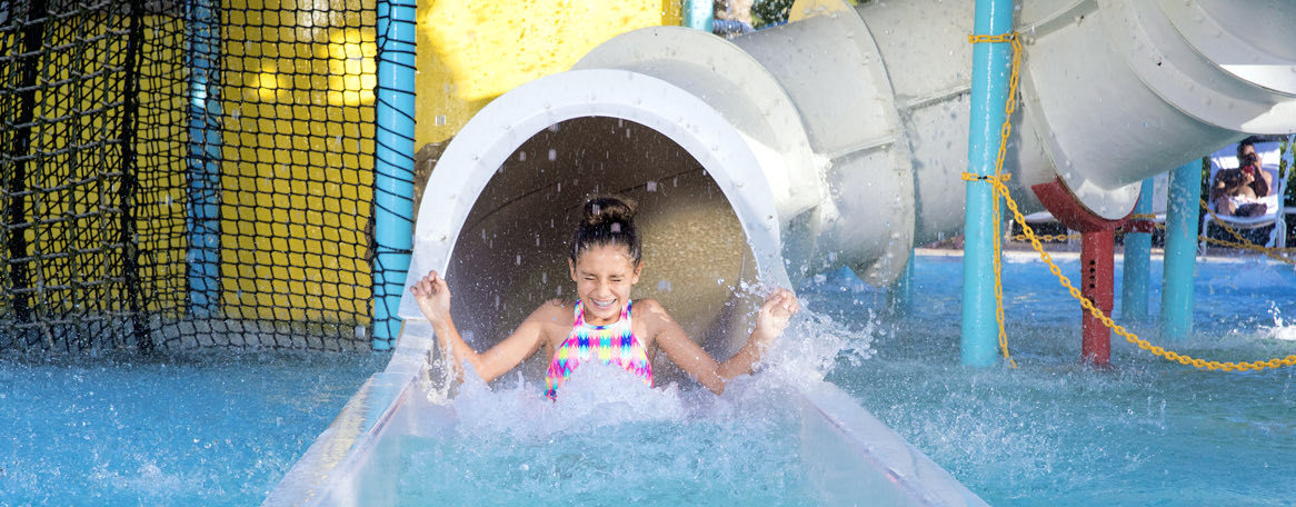 a young girl on a water slide