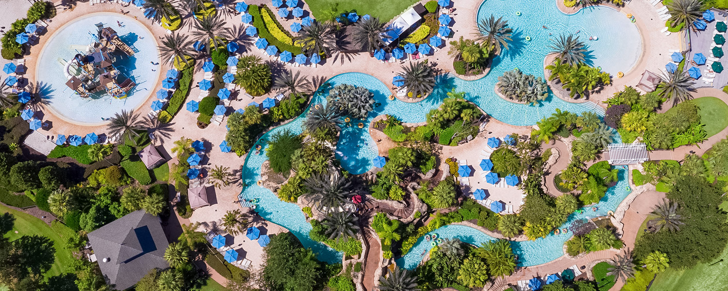 aerial view of hotel property and pools