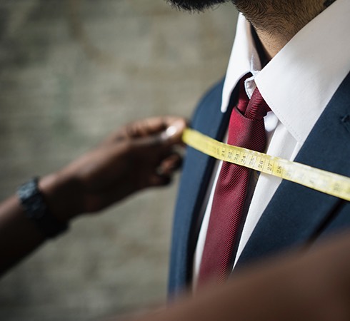 men measuring a suit