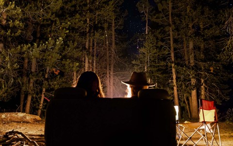 back of people's head sitting by fireplace at night