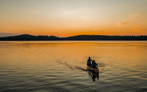 person on a kayak at sunset