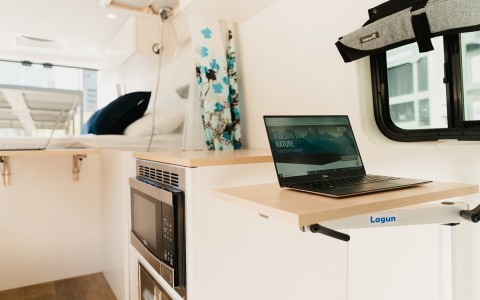 inside of the Roameo van with a laptop on a small table