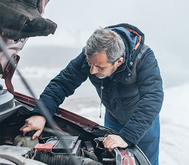 View of a person fixing a car
