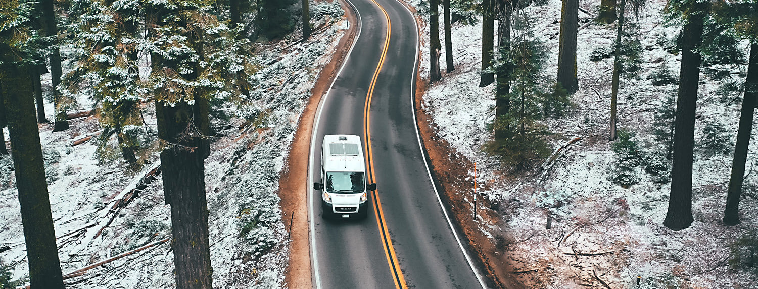 van driving on a highway near snow