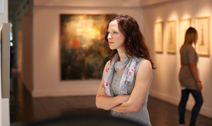 woman looking at art intensely in a museum or gallery