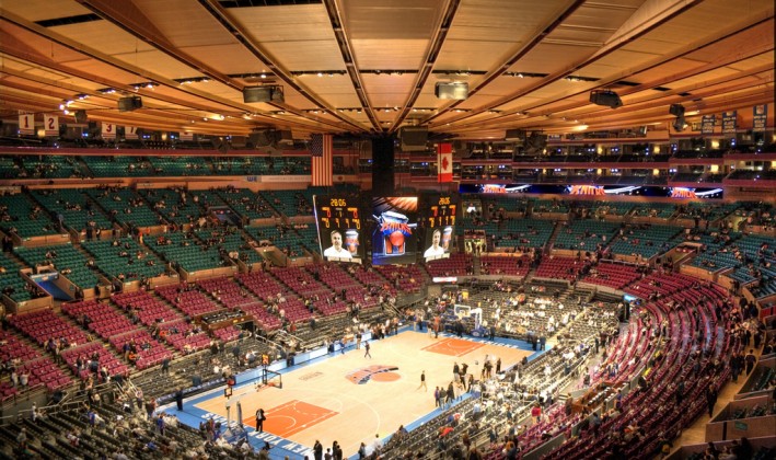 aerial view of basketball game being played in full arena