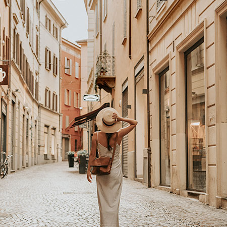 woman walking down a street in rome