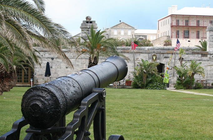 close up of canon in front of antique building