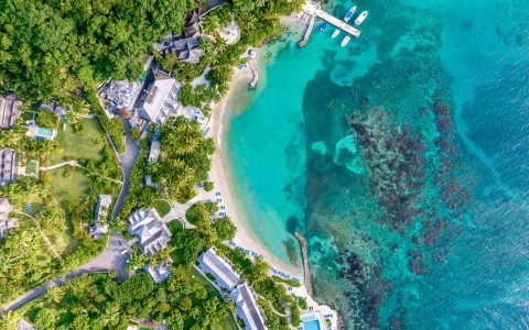 top aerial view of property by the blue ocean