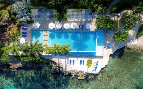top aerial view of the main pool next to the ocean