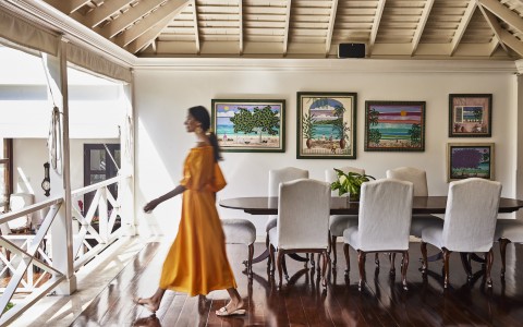woman walking in the villa by the dining table