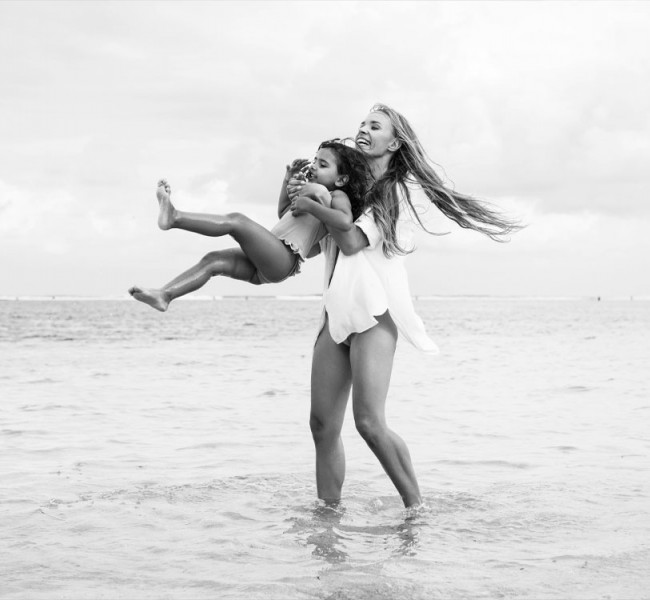 View of a mother and her child playing at the sea
