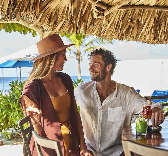 couple looking at each other at the beach bar