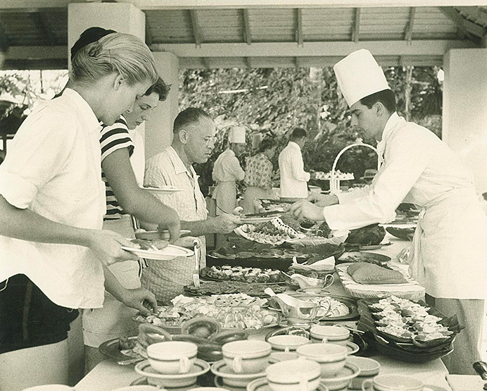 black and white photo of grace kelly serving herself food from buffet