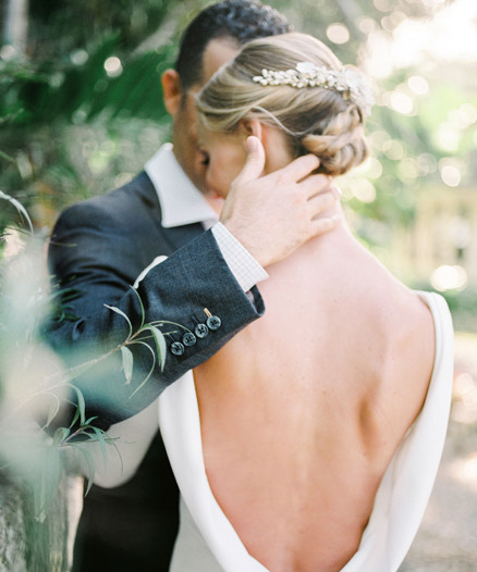 Back view of a bride hugging with the groom 