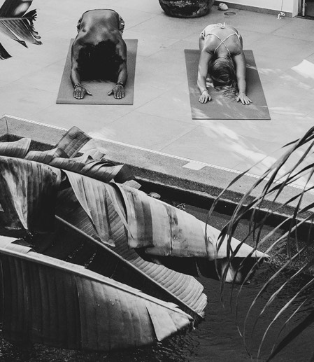 View of two people practicing Yoga outdoors 