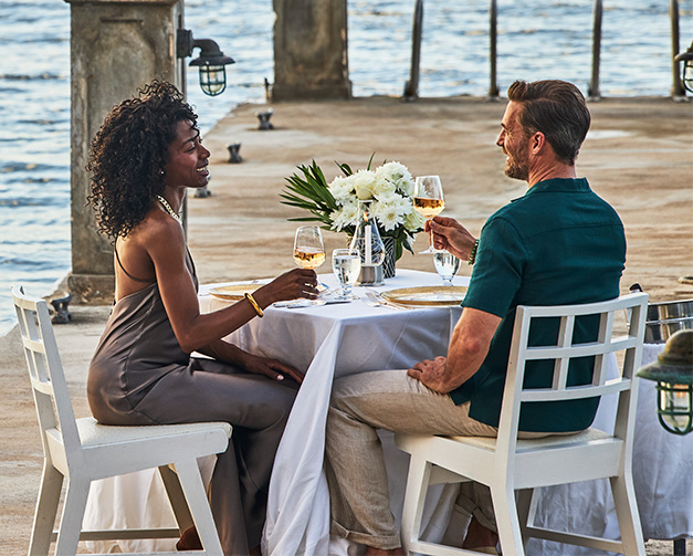 View of a lovely couple having a romantic dinner by the sea