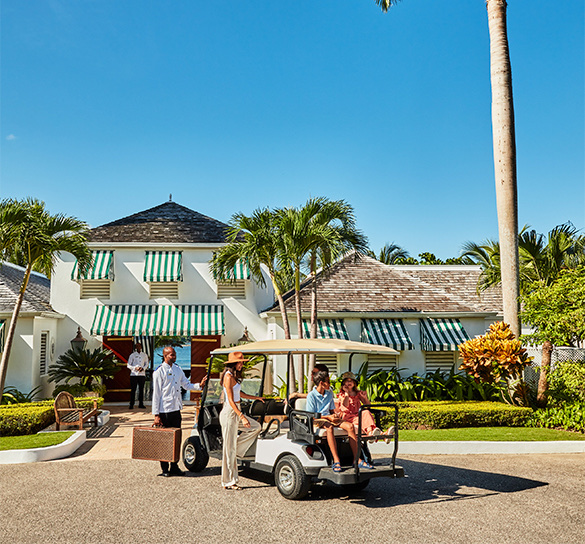 View of a happy family getting on a golf cart in front of the property