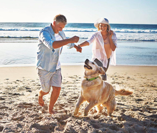 Couple with dog on beach
