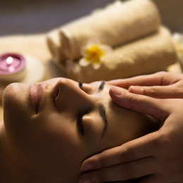 woman on a massage with some towels next to her