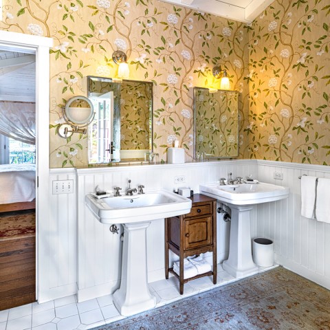 san ysidro rosemary cottage bathroom with two sinks and yellow floral wallpaper