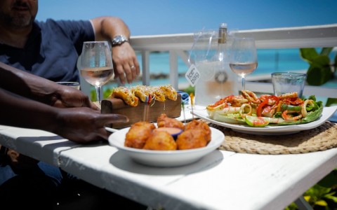 food served on a table overlooking the beach